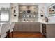 This bar features a built-in wine fridge and shelving that is perfect for displaying decorations and drinks at 2333 Gulf Of Mexico Dr # 1A2, Longboat Key, FL 34228