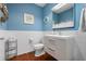Coastal-inspired powder room with shiplap detail and a decorative porthole mirror at 2333 Gulf Of Mexico Dr # 1A2, Longboat Key, FL 34228
