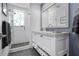 Bright bathroom featuring a walk-in shower with grey tile floor and a marble countertop vanity at 2333 Gulf Of Mexico Dr # 1A2, Longboat Key, FL 34228