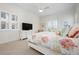 Cozy bedroom featuring a decorative fan, white dresser, and french doors at 2333 Gulf Of Mexico Dr # 1A2, Longboat Key, FL 34228