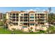 Beautiful multi-story condo boasts a classic design with a lush lawn and mature palm trees at 2333 Gulf Of Mexico Dr # 1A2, Longboat Key, FL 34228