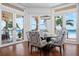 Charming dining area with beautiful ocean views, hardwood floors, and stylish patterned chairs at 2333 Gulf Of Mexico Dr # 1A2, Longboat Key, FL 34228