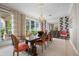 An elegant dining room with large windows, hardwood floors, and seating for six at 2333 Gulf Of Mexico Dr # 1A2, Longboat Key, FL 34228