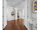 Inviting foyer features a white console table, dark hardwood floors, and an arched entryway at 2333 Gulf Of Mexico Dr # 1A2, Longboat Key, FL 34228