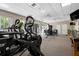 A full gym, complete with weights and machines, with natural light from the doors leading outside at 2333 Gulf Of Mexico Dr # 1A2, Longboat Key, FL 34228