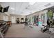 Full gym equipment, with a bench and weights, and light coming in from the exterior at 2333 Gulf Of Mexico Dr # 1A2, Longboat Key, FL 34228