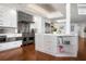 This bright kitchen features stainless steel appliances, a kitchen island with a marble countertop, and hardwood flooring at 2333 Gulf Of Mexico Dr # 1A2, Longboat Key, FL 34228
