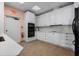 A galley style kitchen with modern appliances, white cabinetry, and light countertops at 2333 Gulf Of Mexico Dr # 1A2, Longboat Key, FL 34228