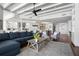 Bright, open-concept living room flowing into a kitchen, featuring modern furnishings, hardwood floors and coffered ceilings at 2333 Gulf Of Mexico Dr # 1A2, Longboat Key, FL 34228