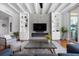 Inviting living room with a contemporary fireplace, built-in shelving, and hardwood floors at 2333 Gulf Of Mexico Dr # 1A2, Longboat Key, FL 34228