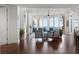 Bright living room features stylish seating, hardwood flooring, and ocean views at 2333 Gulf Of Mexico Dr # 1A2, Longboat Key, FL 34228