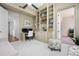 Dedicated office space featuring built-in bookshelves, desk, and comfortable seating arrangement at 2333 Gulf Of Mexico Dr # 1A2, Longboat Key, FL 34228