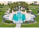 Beautiful turquoise swimming pool with ample lounge chairs and manicured landscaping in resort setting at 2333 Gulf Of Mexico Dr # 1A2, Longboat Key, FL 34228