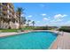 A pool with a view of the beach, lounge chairs, and neighboring condos at 2333 Gulf Of Mexico Dr # 1A2, Longboat Key, FL 34228