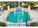 A close-up of a sparkling pool featuring lounge chairs, and meticulously maintained landscaping at 2333 Gulf Of Mexico Dr # 1A2, Longboat Key, FL 34228