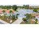 Aerial view of a well-maintained house, waterfront and surrounding landscaping at 2435 E Del Webb Blvd, Sun City Center, FL 33573