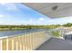 Balcony with white railings offering scenic views of the waterfront at 2435 E Del Webb Blvd, Sun City Center, FL 33573