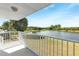 Balcony with white railings offering scenic views of the waterfront at 2435 E Del Webb Blvd, Sun City Center, FL 33573