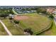 A well-maintained baseball field with grass and clay, surrounded by trees, and fencing at 2435 E Del Webb Blvd, Sun City Center, FL 33573
