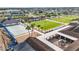 Aerial view of community amenities including a tennis court, lawn bowling, and outdoor grilling areas at 2435 E Del Webb Blvd, Sun City Center, FL 33573