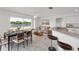 Dining area with a modern table set, scenic water view, and open to the breakfast bar and kitchen at 2435 E Del Webb Blvd, Sun City Center, FL 33573