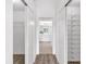 Hallway leading to bathroom showcases closet space and ceramic tile flooring at 2435 E Del Webb Blvd, Sun City Center, FL 33573