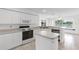 Bright and airy kitchen with white cabinets, modern appliances, and a lovely view of the lake at 2435 E Del Webb Blvd, Sun City Center, FL 33573