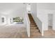 Open living room features high ceilings, access to the lanai, and staircase at 2435 E Del Webb Blvd, Sun City Center, FL 33573