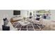 Bright living room with neutral furniture, a cozy rug, and sliding doors to the lanai and waterfront view at 2435 E Del Webb Blvd, Sun City Center, FL 33573