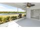 Screened porch with view of landscaping and waterfront at 2435 E Del Webb Blvd, Sun City Center, FL 33573