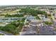 Aerial view of a community center and many well-maintained tennis courts in a scenic setting at 2435 E Del Webb Blvd, Sun City Center, FL 33573