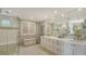 Bright bathroom features double sinks, a large mirror, and a walk-in shower at 2450 Harbourside Dr # 251, Longboat Key, FL 34228