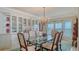 Charming dining room with glass table, chandelier, and built-in china cabinets at 2450 Harbourside Dr # 251, Longboat Key, FL 34228