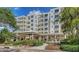 Beautifully landscaped exterior featuring a white building with manicured gardens and water feature at 2450 Harbourside Dr # 251, Longboat Key, FL 34228