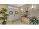 Inviting condo foyer with double doors, decorative wreaths, and stylish console table at 2450 Harbourside Dr # 251, Longboat Key, FL 34228