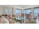 Bright and airy living room boasting water views, comfortable seating, and a ceiling fan at 2450 Harbourside Dr # 251, Longboat Key, FL 34228
