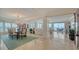 Elegant living room with marble floors, water views, and an adjacent dining area at 2450 Harbourside Dr # 251, Longboat Key, FL 34228