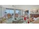 Sunlit living room with elegant furnishings, stunning water views, and a wet bar area at 2450 Harbourside Dr # 251, Longboat Key, FL 34228