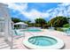 Beautiful pool and spa area featuring blue lounge chairs and lovely landscaping at 2450 Harbourside Dr # 251, Longboat Key, FL 34228