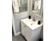 Modern bathroom featuring a white vanity, a silver framed mirror, and updated fixtures at 2601 Pine Lake Ter # B, Sarasota, FL 34237