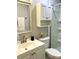 Clean bathroom with a white vanity, mirrored cabinet, toilet, and shower at 2601 Pine Lake Ter # B, Sarasota, FL 34237
