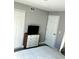 A bedroom featuring neutral colored walls, a modern dresser with a TV, and a closet at 2601 Pine Lake Ter # B, Sarasota, FL 34237