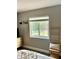Bright bedroom showcasing a large window and a decorative ladder near a comfortable bed at 2601 Pine Lake Ter # B, Sarasota, FL 34237