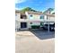 Building exterior featuring carport parking and well-maintained landscaping at 2601 Pine Lake Ter # B, Sarasota, FL 34237