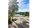 Outdoor patio area with seating and a view of the lake with palm trees at 2601 Pine Lake Ter # B, Sarasota, FL 34237