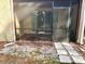 Enclosed screen patio with patio furniture and a stone pathway leading to the yard at 2601 Pine Lake Ter # B, Sarasota, FL 34237