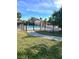 Community pool featuring a black metal fence and lush, tropical landscaping at 2601 Pine Lake Ter # B, Sarasota, FL 34237