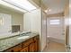 Bathroom features granite countertop, wood cabinets, and tile flooring at 2817 La Mancha Ct, Punta Gorda, FL 33950
