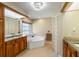 This bathroom offers a tub, granite counters, and a glass block window at 2817 La Mancha Ct, Punta Gorda, FL 33950