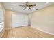 Bedroom features hardwood floors, a ceiling fan, and a closet at 2817 La Mancha Ct, Punta Gorda, FL 33950